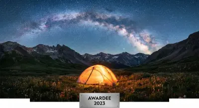 AI: A glowing camping tent in a remote mountain valley 
under the spectacular Milky...